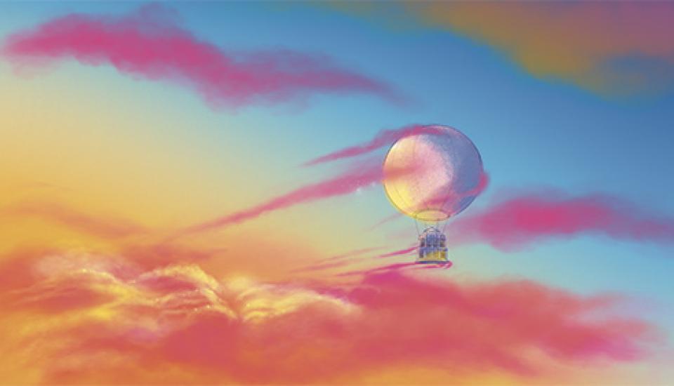 Ballon-montgolfière transportant l'Opéra de Rennes dans le ciel au coucher de soleil, avec des nuages
